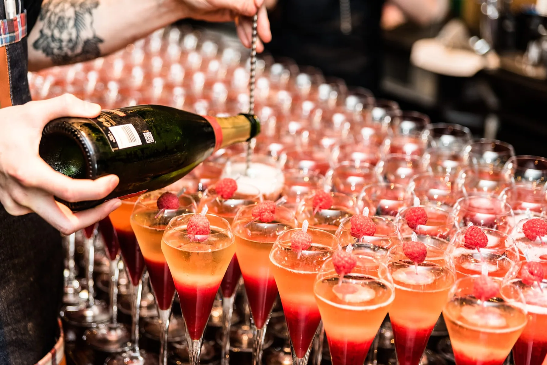 Sparkling wine being poured into glasses.