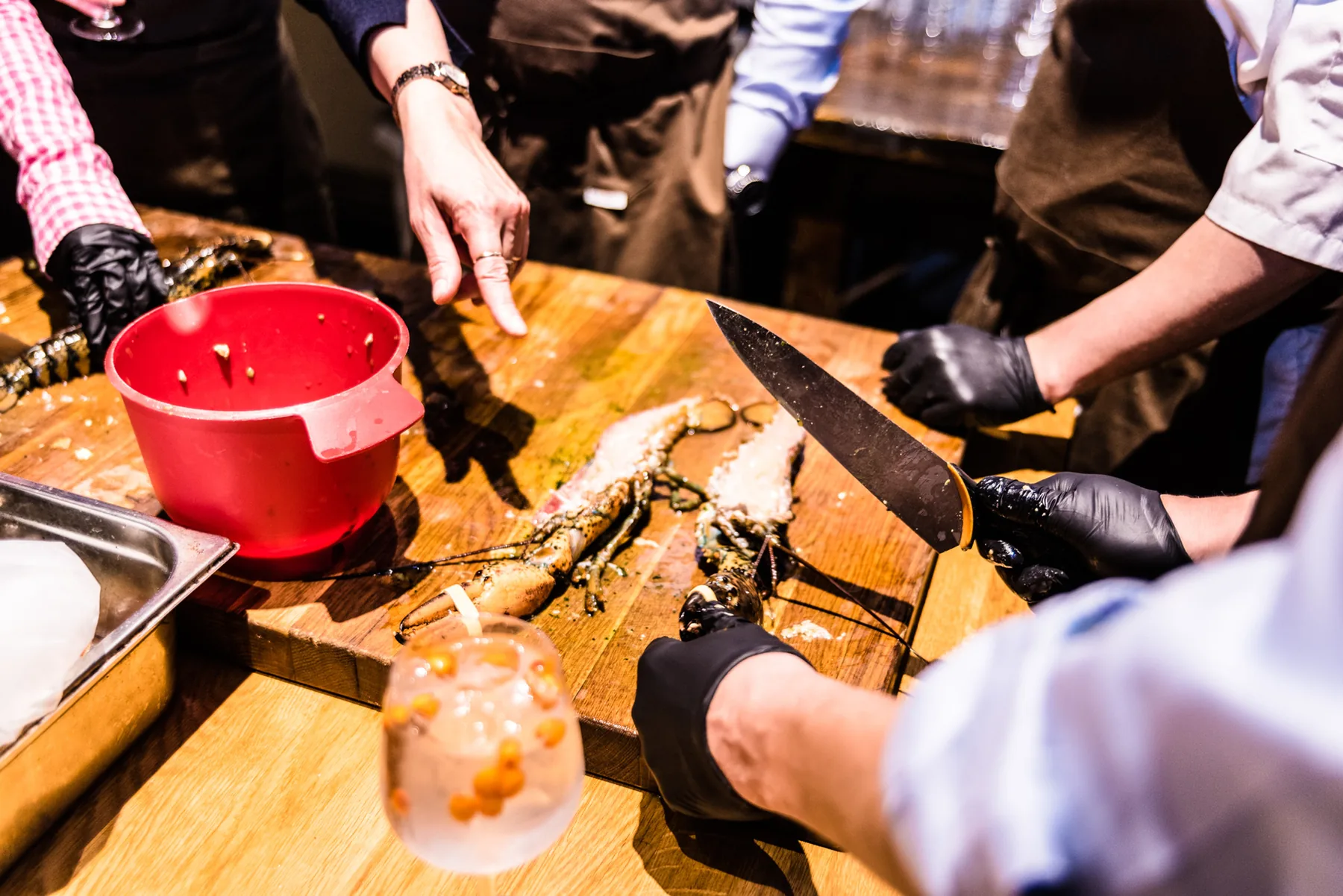 Hands preparing a dish on a wooden board.