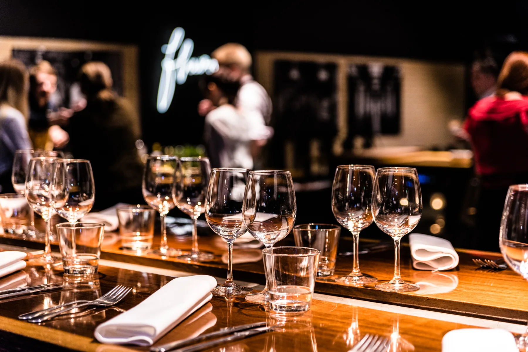 A table set with wine glasses at Flavour Studio.