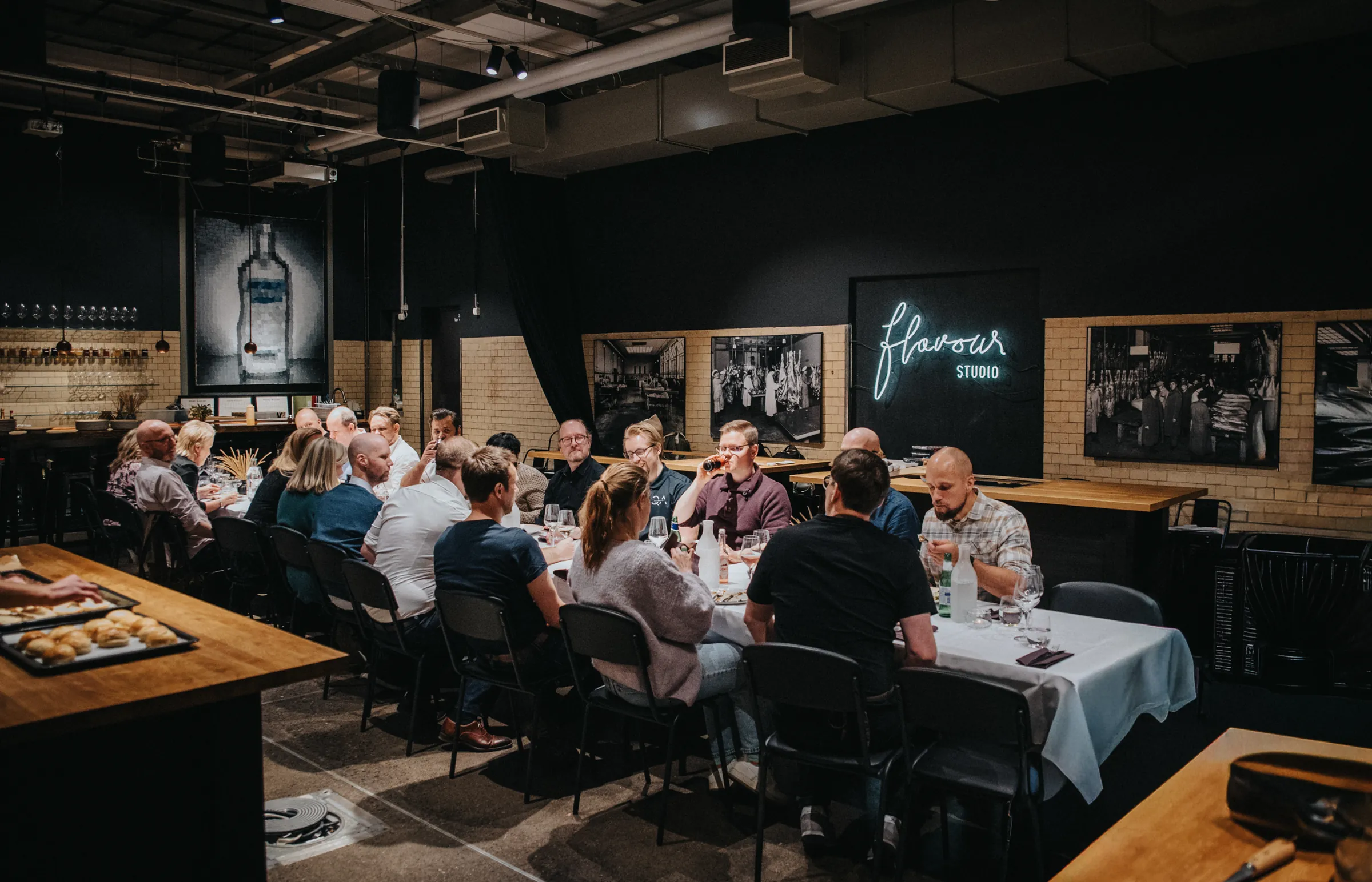 Dinner guests at the tables in the Flavour Studio room.