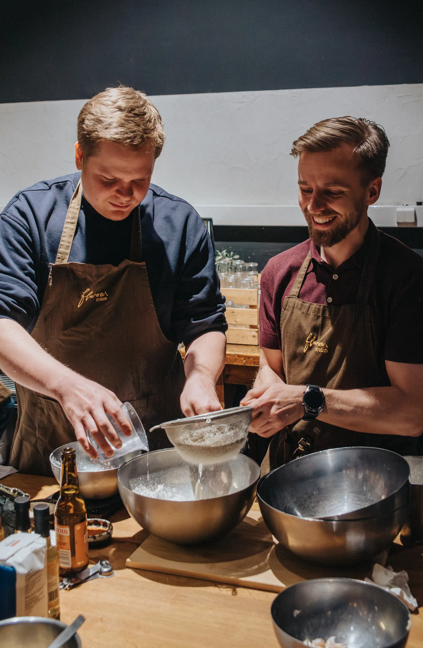 Two guests preparing a dish together.