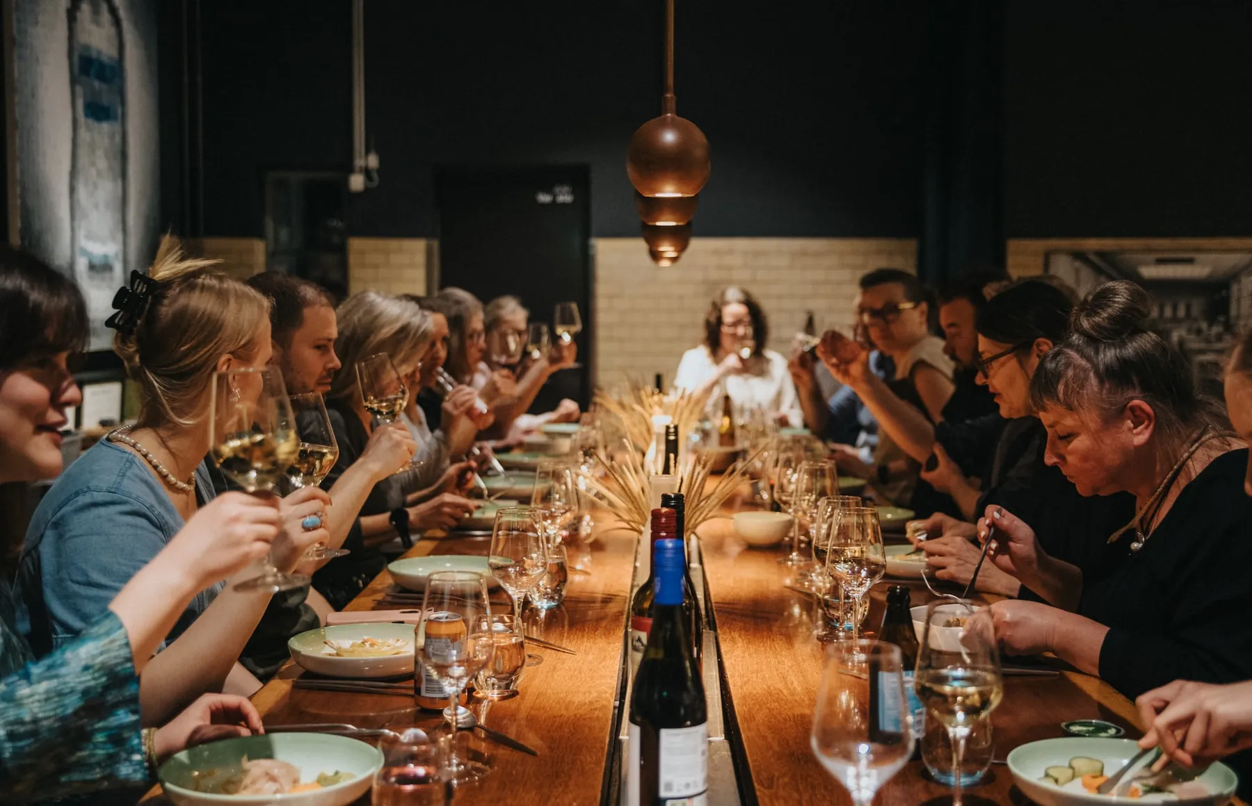 A long table full of dinner guests.